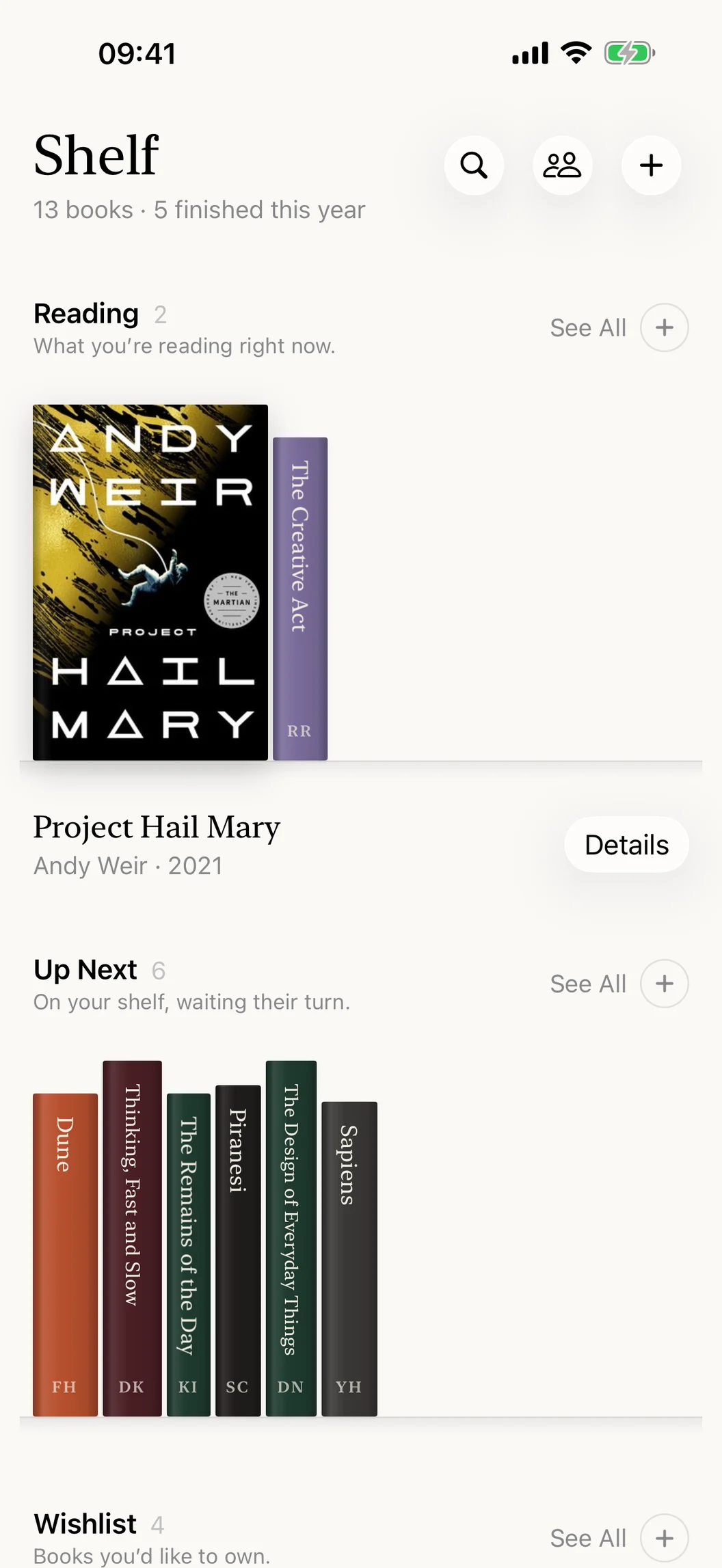 Shelf on iPhone: the library, with the Reading and Up Next shelves and their books spine out